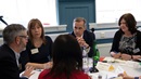 Mark Carney involved in group discussions at the community forum in Glasgow