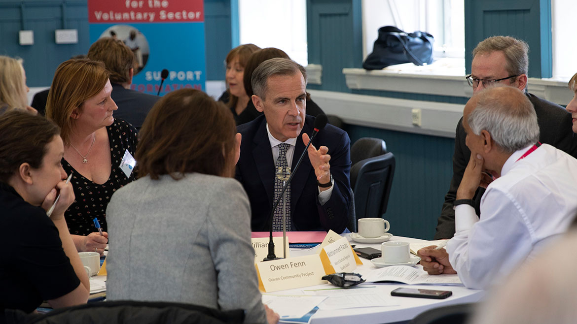 Mark Carney in group discussion at the Community Forum in Glasgow
