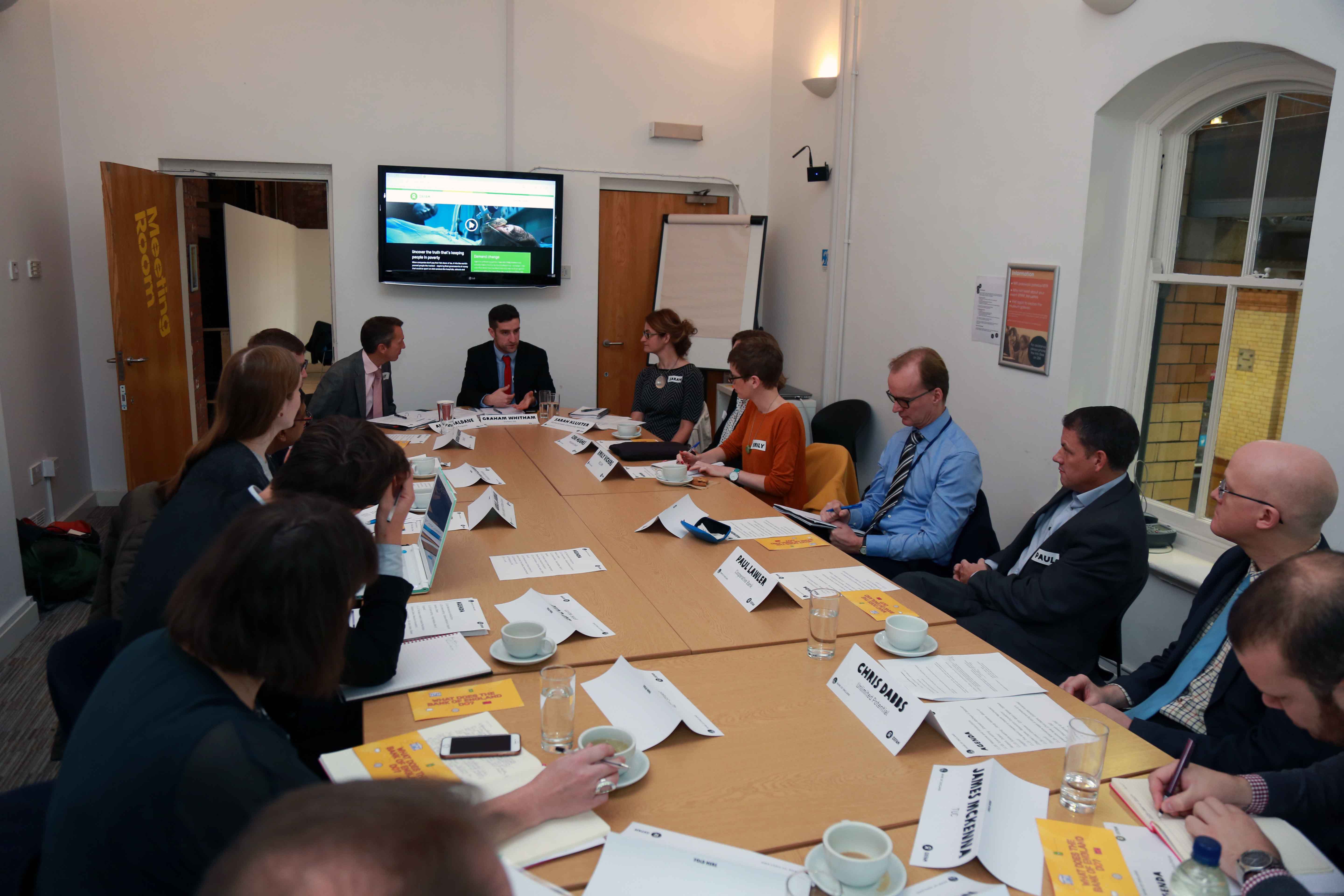 Group of people having a discussion around a table