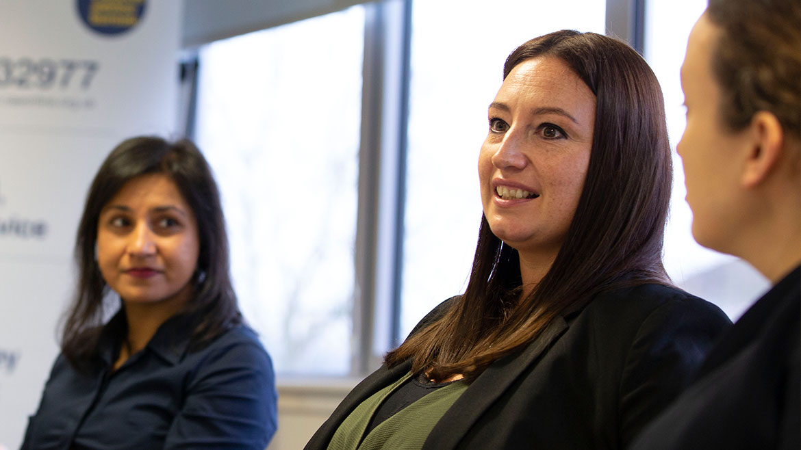 People speaking at a meeting