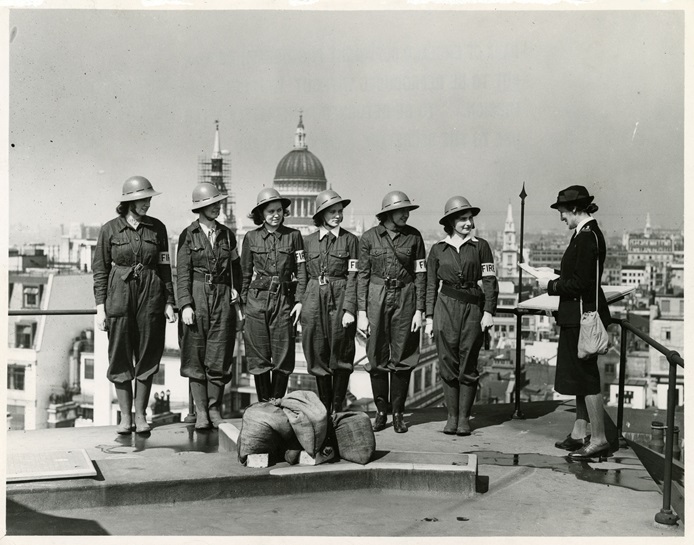 Women Fire Guards practicing on the roof of the Bank, Threadneedle Street 1942 (Archive reference: 15A13/1/4/22) Group of Women in fire guards uniform