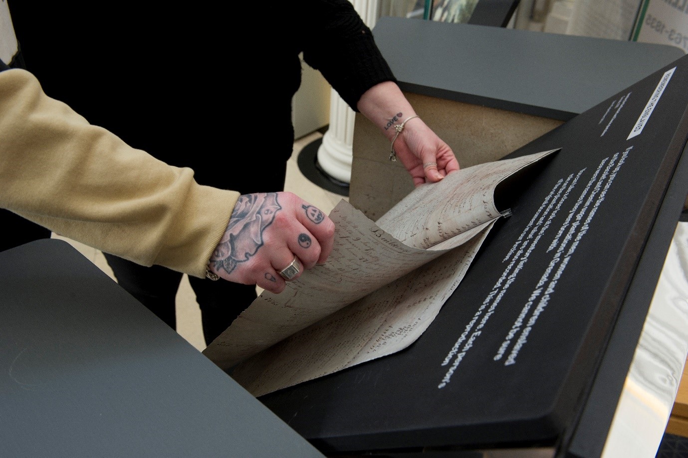 Museum visitors with a facsimile of the Bacolet and Chemin inventory, Bank of England Museum